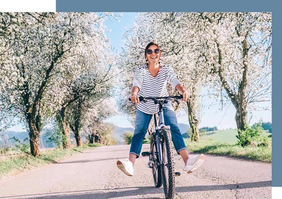 Woman riding bike feeling good having fun with no pain